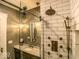 Elegant bathroom with granite countertop, ornate lighting, and tiled shower with sliding glass door at 414 E Main St, Plainfield, IN 46168