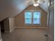 Attic bedroom featuring carpet, window with blinds, ceiling fan, and neutral paint at 414 E Main St, Plainfield, IN 46168