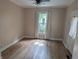 Bedroom featuring wood floors, a ceiling fan, and a window with curtains and blinds at 414 E Main St, Plainfield, IN 46168