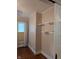 Bedroom featuring hardwood floors, a window with blinds, and built in shelving at 414 E Main St, Plainfield, IN 46168
