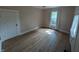 Bedroom featuring wood floors, a window with curtains and blinds and a closet at 414 E Main St, Plainfield, IN 46168