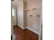 Bedroom featuring hardwood floors, a window with blinds, and built in shelving at 414 E Main St, Plainfield, IN 46168