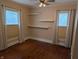 Bedroom featuring hardwood floors, and two windows with curtains and blinds at 414 E Main St, Plainfield, IN 46168
