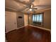 Cozy bedroom with hardwood floors, ceiling fan, and lots of natural light at 414 E Main St, Plainfield, IN 46168
