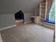Attic bedroom with neutral carpet, walk-in access, built in shelving and window seat at 414 E Main St, Plainfield, IN 46168