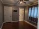 Comfortable bedroom with hardwood floors, ceiling fan, and a view of the outside at 414 E Main St, Plainfield, IN 46168