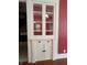 Dining room cabinet featuring hardwood floors, red paint, and a light fixture at 414 E Main St, Plainfield, IN 46168