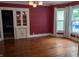 Dining room featuring hardwood floors, red paint, and a built-in cabinet at 414 E Main St, Plainfield, IN 46168