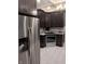 Beautiful kitchen featuring stainless steel refrigerator and dark cabinets and countertops at 414 E Main St, Plainfield, IN 46168