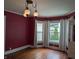 Sun-drenched living room with hardwood floors, updated windows, and stylish light fixtures at 414 E Main St, Plainfield, IN 46168