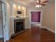 Living room featuring a fireplace, hardwood floors, and neutral paint at 414 E Main St, Plainfield, IN 46168