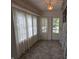 Bright sunroom featuring tiled floors, sheer curtains, and a star-shaped pendant light fixture at 414 E Main St, Plainfield, IN 46168