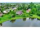 Aerial view of the community and the property, featuring a pond, surrounding houses, and mature trees at 4279 Redwood Ct, Zionsville, IN 46077