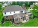 Aerial view of a home showcasing a patio with pergola and outdoor seating, plus lush lawn and landscaping at 4279 Redwood Ct, Zionsville, IN 46077
