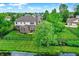 Aerial view of the backyard featuring a fenced yard with landscaped lawn and trees at 4279 Redwood Ct, Zionsville, IN 46077
