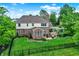 Aerial view featuring the backyard with a pergola, patio furniture, and manicured lawn at 4279 Redwood Ct, Zionsville, IN 46077