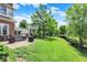 Spacious backyard with lush lawn, brick home, and patio area, offering a perfect blend of comfort and nature at 4279 Redwood Ct, Zionsville, IN 46077