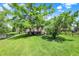 Backyard with a pond view, green lawn, and mature trees, offering a serene and private outdoor space at 4279 Redwood Ct, Zionsville, IN 46077