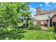 Private backyard with a pond view, patio, and manicured lawn, providing a tranquil and picturesque setting at 4279 Redwood Ct, Zionsville, IN 46077
