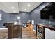 Finished basement features a stylish bar area with granite countertops and wine fridge at 4279 Redwood Ct, Zionsville, IN 46077