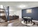 Finished basement area with stairs, a comfortable sofa, and a dining table set at 4279 Redwood Ct, Zionsville, IN 46077
