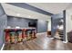 Finished basement featuring a bar with four stools and dark-colored accent wall at 4279 Redwood Ct, Zionsville, IN 46077