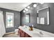 Well-lit bathroom featuring double sinks, modern fixtures, and a neutral color palette at 4279 Redwood Ct, Zionsville, IN 46077