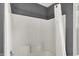 Clean bathroom featuring white tile and a shower with a white curtain at 4279 Redwood Ct, Zionsville, IN 46077