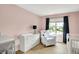 Light-filled Bedroom featuring a crib, chair, and ample storage space at 4279 Redwood Ct, Zionsville, IN 46077