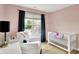 Comfortable Bedroom space showcasing a crib, chair, and window view at 4279 Redwood Ct, Zionsville, IN 46077