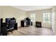 Bright bedroom with light wood floors and two windows providing natural light at 4279 Redwood Ct, Zionsville, IN 46077