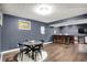 Basement with dining table, bar seating, wood floors and modern decor create a cozy gathering space at 4279 Redwood Ct, Zionsville, IN 46077
