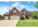 Charming two-story brick home with a well-maintained lawn and an attached three-car garage at 4279 Redwood Ct, Zionsville, IN 46077