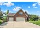 Attractive brick home with a three-car garage, lush landscaping, and a spacious driveway at 4279 Redwood Ct, Zionsville, IN 46077
