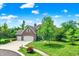Attractive brick home featuring a well-maintained lawn, mature trees, and an attached two-car garage at 4279 Redwood Ct, Zionsville, IN 46077