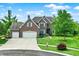 Charming two-story brick home with a well-manicured lawn and attached two-car garage showcasing great curb appeal at 4279 Redwood Ct, Zionsville, IN 46077