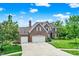 Beautiful brick home with attached two-car garage, surrounded by a lush green lawn and mature trees at 4279 Redwood Ct, Zionsville, IN 46077