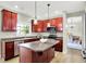Modern kitchen showcasing stainless appliances, ample counter space, and cherry-toned cabinets at 4279 Redwood Ct, Zionsville, IN 46077