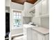 Bright laundry room with modern washer and dryer, and natural light from large window at 4279 Redwood Ct, Zionsville, IN 46077