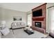 Cozy living room showcasing a brick fireplace with TV, with comfortable seating at 4279 Redwood Ct, Zionsville, IN 46077
