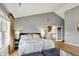 Well-lit main bedroom featuring vaulted ceiling, a large bed, and hardwood floors at 4279 Redwood Ct, Zionsville, IN 46077