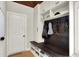 Mudroom with storage shelves, bench, coat hooks, and an exterior door at 4279 Redwood Ct, Zionsville, IN 46077