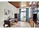 Home office with custom trim, unique ceiling, hardwood floors, and natural light from large window at 4279 Redwood Ct, Zionsville, IN 46077