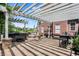 Covered outdoor kitchen with a hot tub, tile flooring, and brick posts perfect for relaxing and entertaining at 4279 Redwood Ct, Zionsville, IN 46077