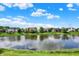 Scenic view of a tranquil pond surrounded by well-maintained homes in a peaceful community at 4279 Redwood Ct, Zionsville, IN 46077