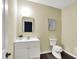Basement powder room with modern vanity, stylish mirror and updated fixtures at 4279 Redwood Ct, Zionsville, IN 46077