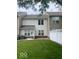 Exterior view of a townhome backyard with grass and a partial brick paver patio at 459 Dekalb Dr, Westfield, IN 46074