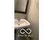 Close up of bathroom sink, ornate mirror, and chrome towel ring at 459 Dekalb Dr, Westfield, IN 46074