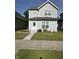 Charming two-story home featuring a well-maintained front yard with flower beds at 46 S Warman S Ave, Indianapolis, IN 46222