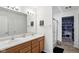 Bathroom features a double vanity with modern fixtures, a walk in shower, and storage at 4643 Darla Ct, Indianapolis, IN 46239